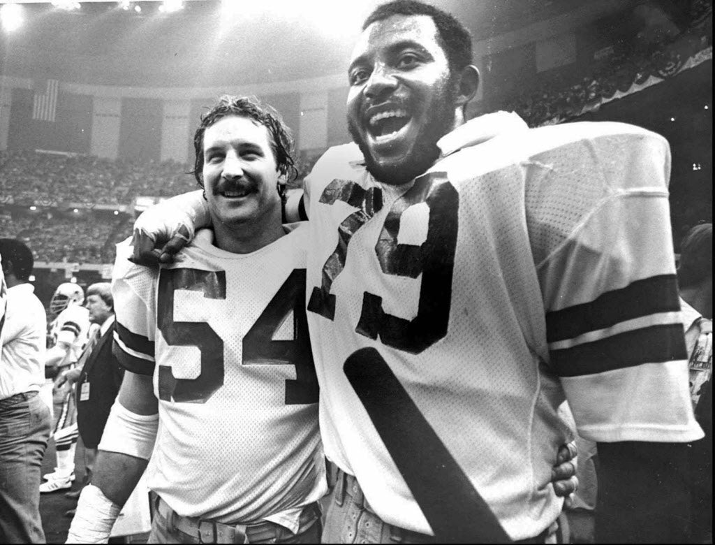 Randy White celebrating on a field with stadium lights in the background