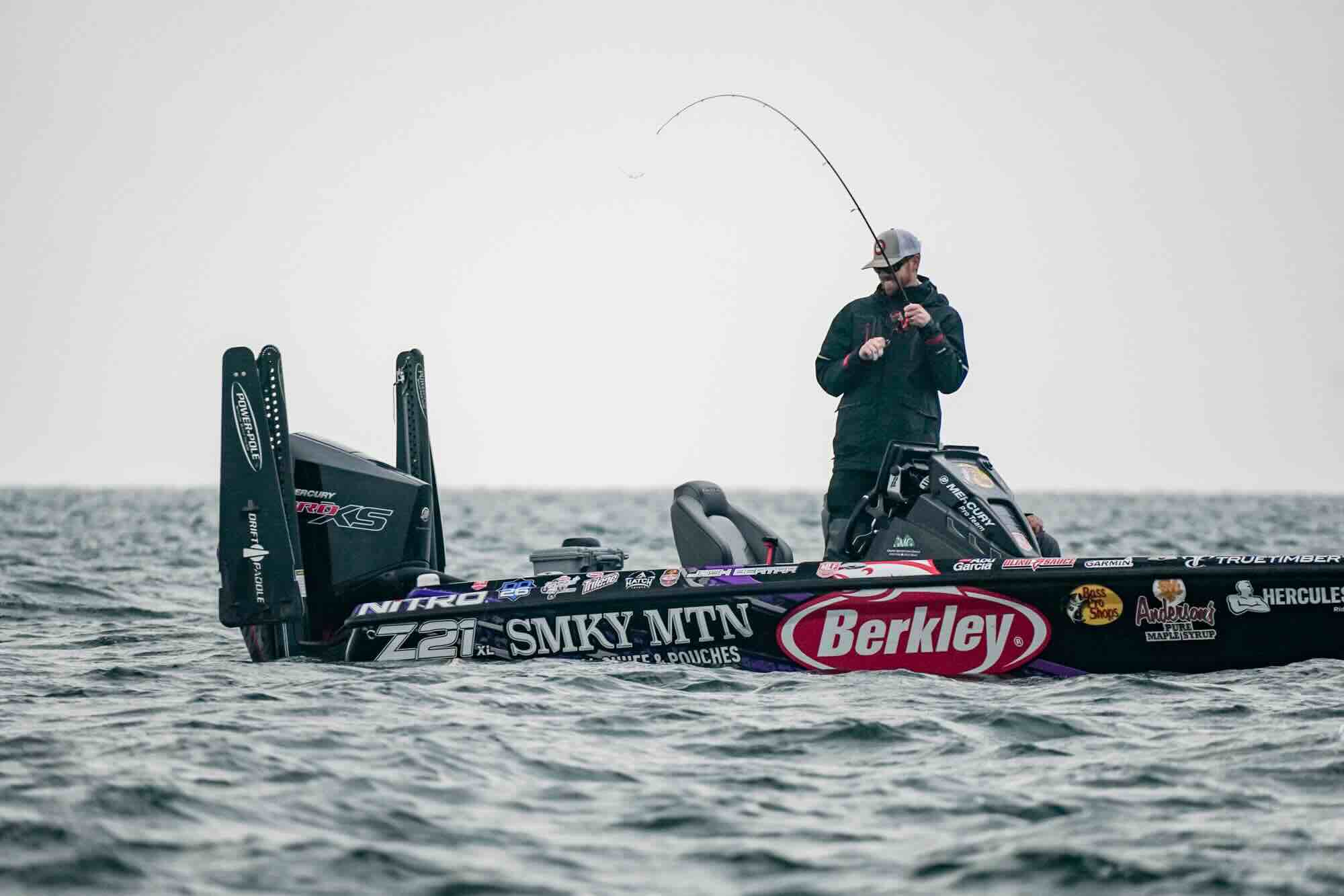 Fishing boat with a Josh Bertrand on it, fishing in the water.