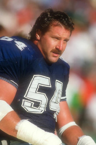 Randy White wearing a football jersey with number 54 on a sports field