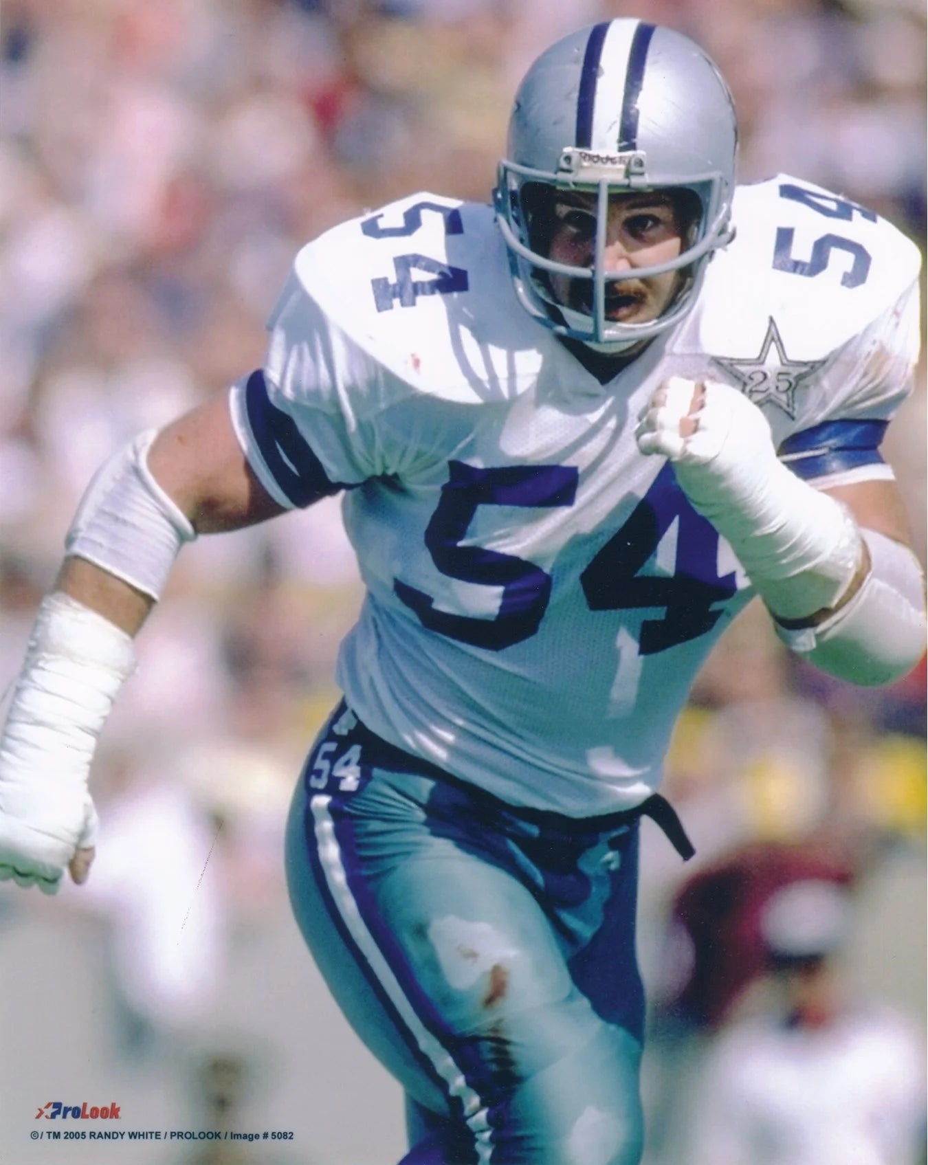 Randy White in a white and blue uniform with number 54 on a blurred background